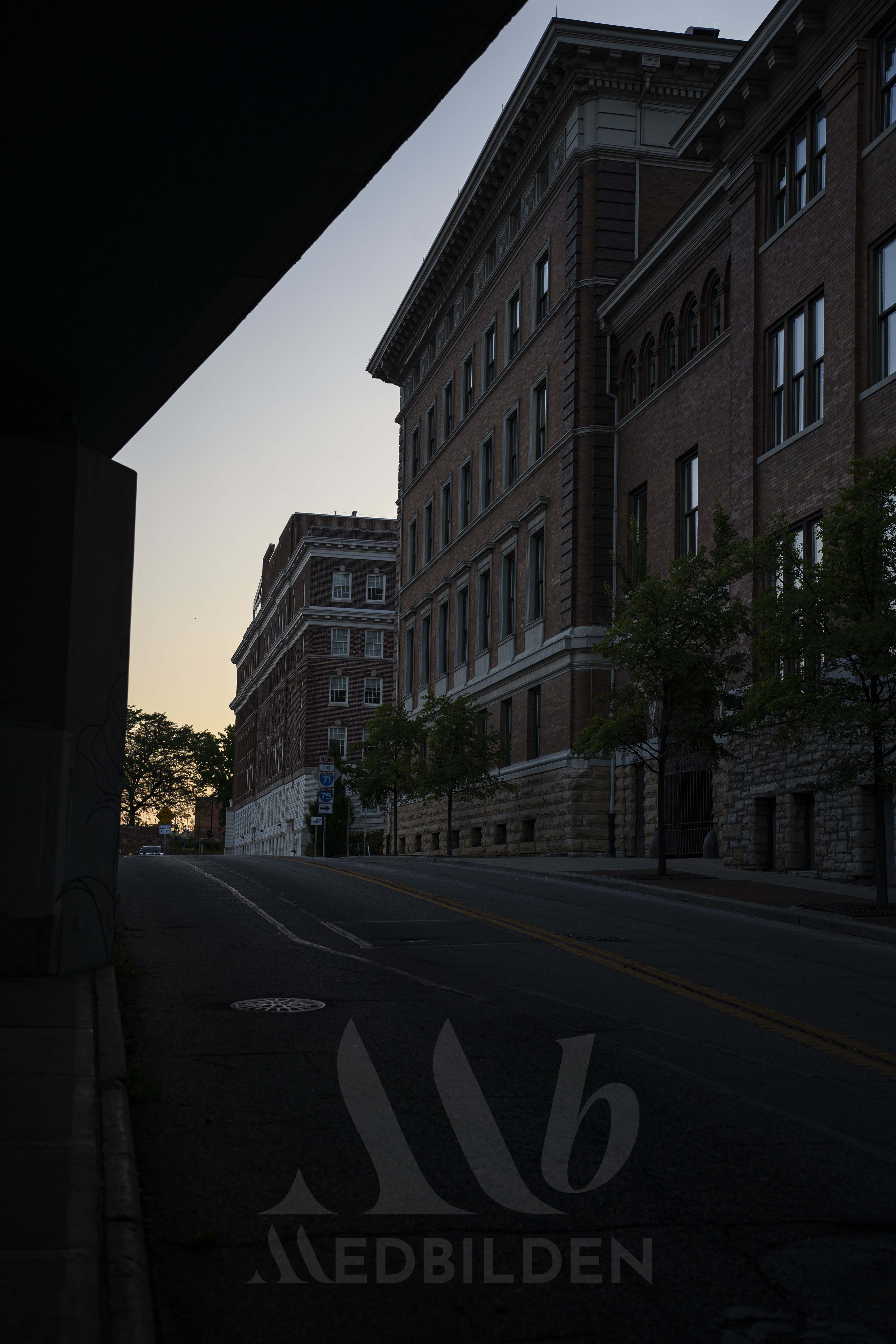 downtown Cincinnati under bridge at sunset